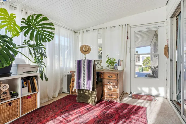 a bedroom with furniture and a potted plant
