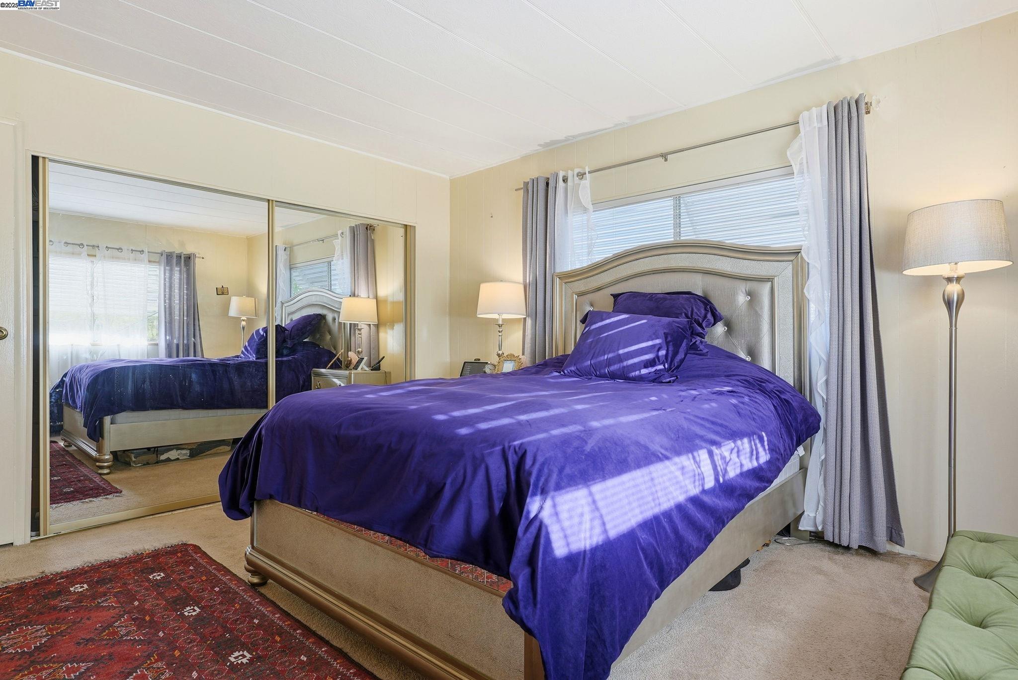 4141 Deep Creek Road, Unit 89 Fremont, CA 94555 - Photo 27 of 54 a bedroom with a large bed and a mirror