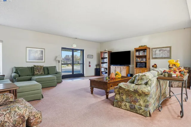 a view of a a dining room with furniture window and wooden floor