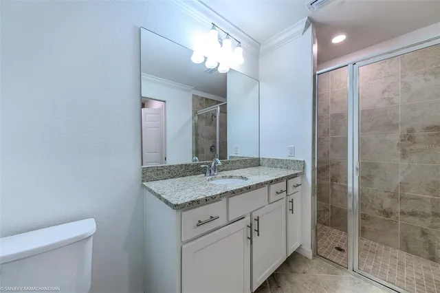 a living room with furniture flowerpot and wooden floor