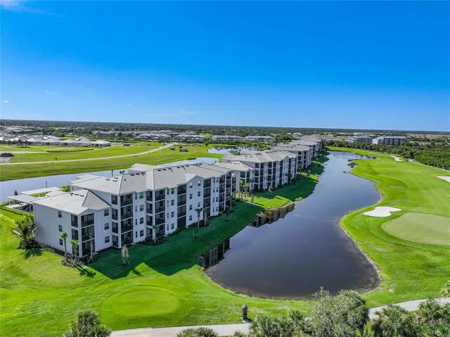 a view of a kitchen with a sink and a refrigerator