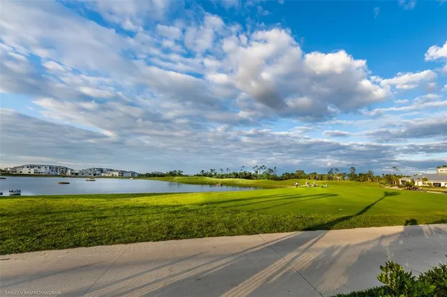 a view of a porch with plants and floor to ceiling window