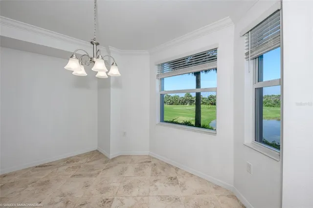 a large white kitchen with stainless steel appliances granite countertop a refrigerator and a sink