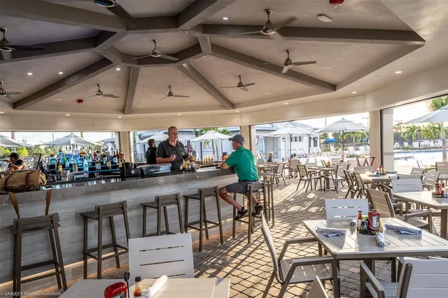a view of a house with a yard and potted plants