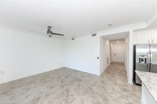 a large kitchen with stainless steel appliances granite countertop a refrigerator a sink and a large window