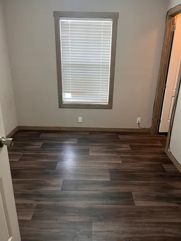 a view of room with window and hardwood floor