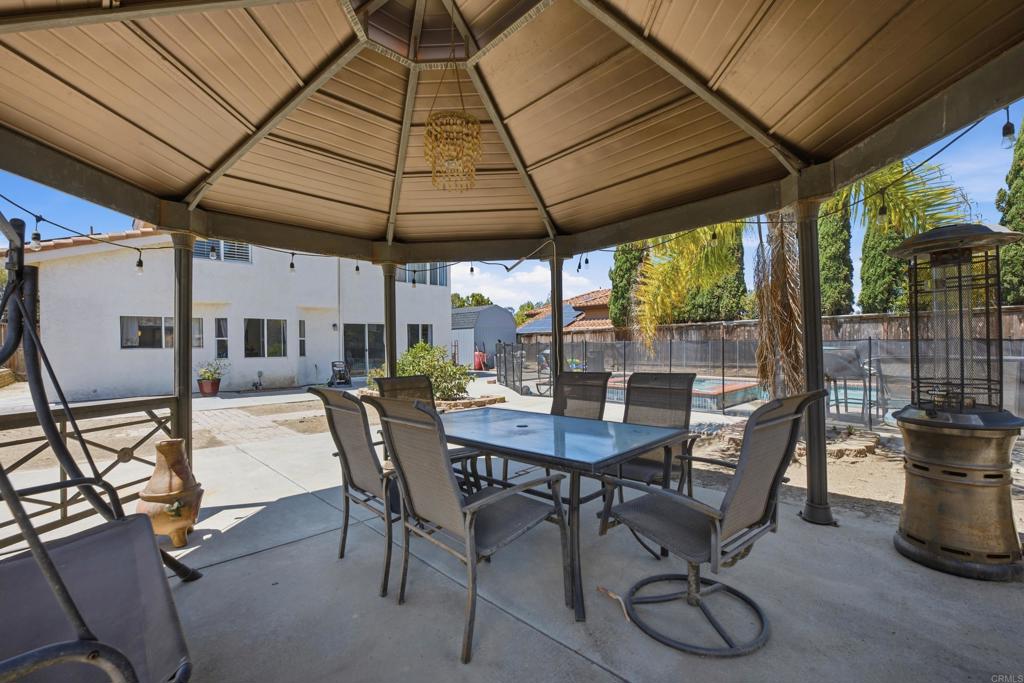 2077 Westwood Road Vista, CA 92083 - Photo 29 of 37 a view of an outdoor dining space with a table and chairs