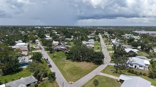 an aerial view of residential houses with city view