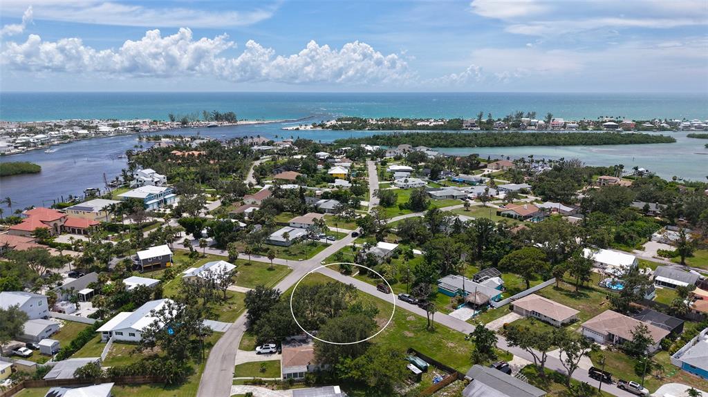 513 Pine Road Nokomis, FL 34275 - Photo 20 of 22 an aerial view of a city with lots of residential buildings ocean and mountain view in back