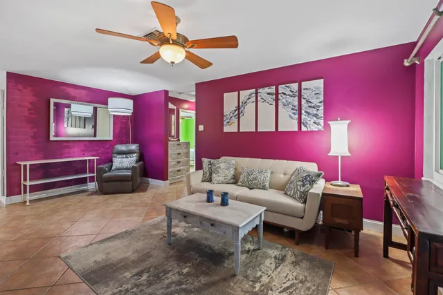 a living room with furniture a rug and a window
