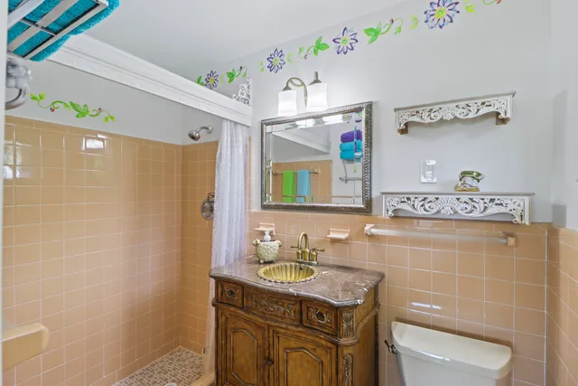 a bathroom with a granite countertop shower a sink and a mirror