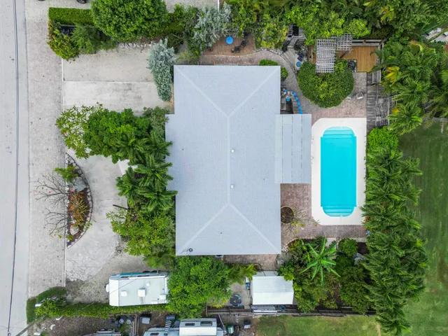 an aerial view of a house with a yard and garden
