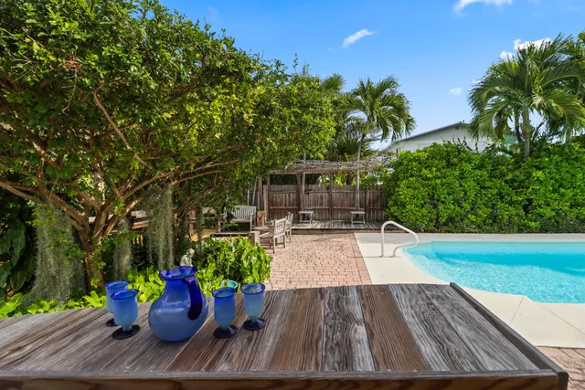 swimming pool view with a seating space