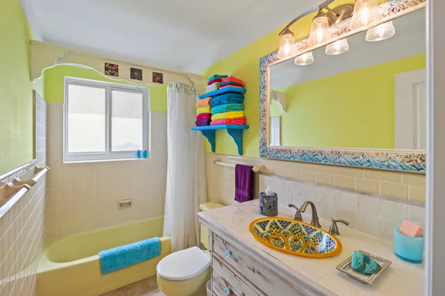 a bathroom with a sink a bath tub and a toilet