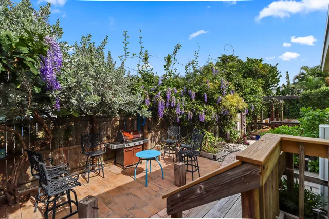 a view of a patio with table and chairs and potted plants