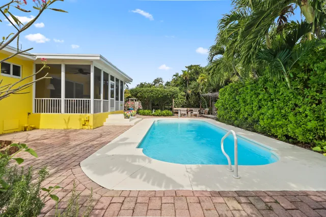 a view of a backyard with chair and table