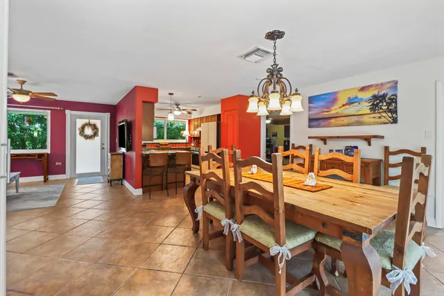 a dining room with furniture a chandelier and window