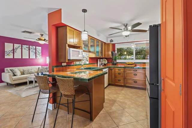 a kitchen with a sink stove and chairs