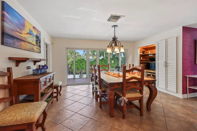 a dining room with furniture a chandelier and window