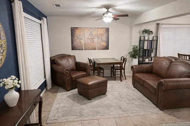 a view of a house with a yard and wooden fence