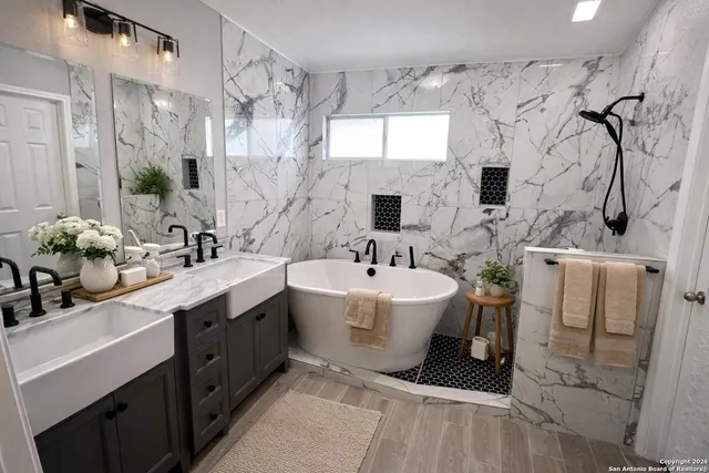 a kitchen with stainless steel appliances a stove sink microwave refrigerator and cabinets