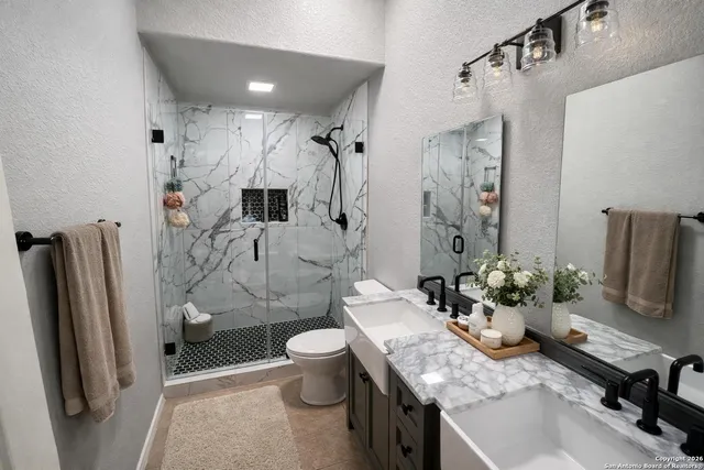 a bedroom with bed and a chandelier