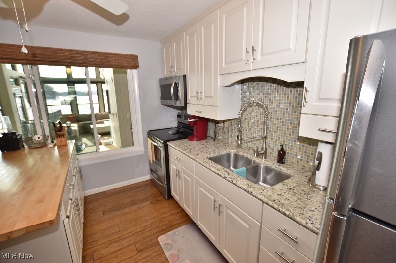 1251 Arrowhead Drive Southwest Dellroy, OH 44620 - Photo 15 of 50 The kitchen features granite countertops, beautiful white cabinetry and a butcher block island providing additional seating