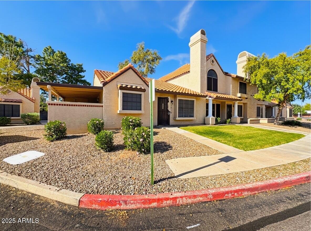 921 West University Drive, Unit 1010 Mesa, AZ 85201 - Photo 1 of 24 a front view of a house with garden