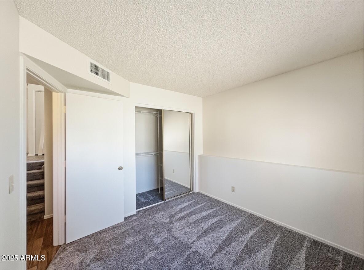 921 West University Drive, Unit 1010 Mesa, AZ 85201 - Photo 14 of 24 a view of a room with an empty space and hallway
