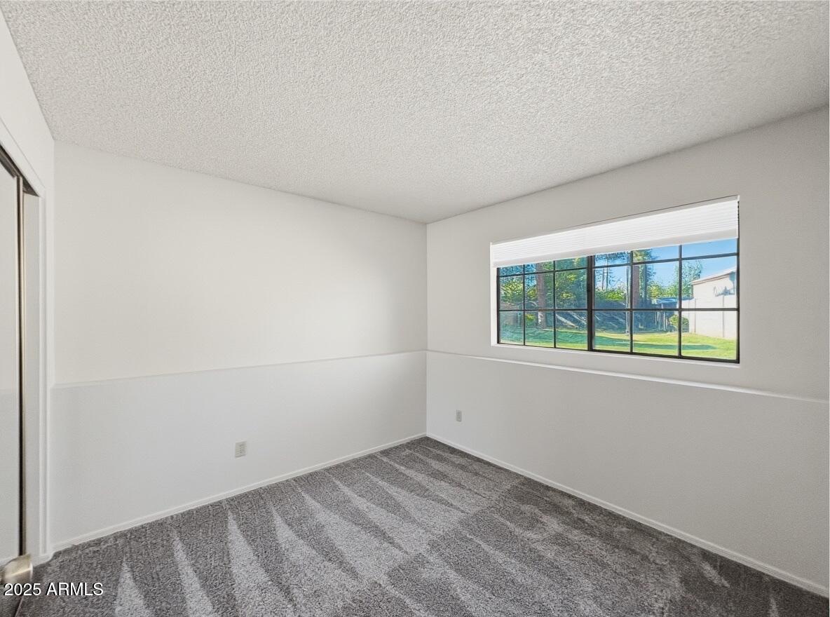 921 West University Drive, Unit 1010 Mesa, AZ 85201 - Photo 18 of 24 an empty room with a window