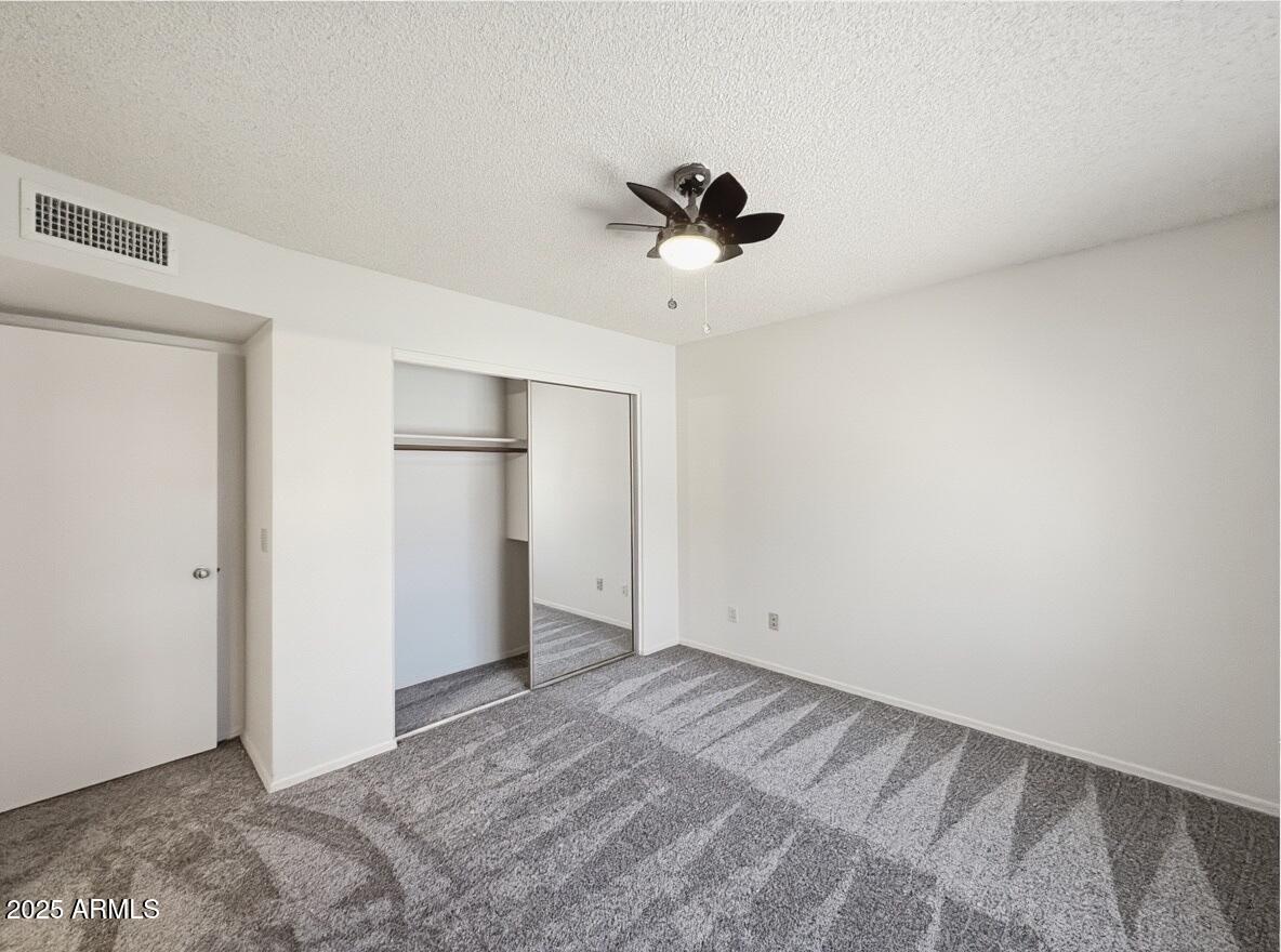 921 West University Drive, Unit 1010 Mesa, AZ 85201 - Photo 19 of 24 a view of empty room with a ceiling fan