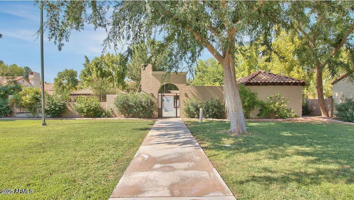 921 West University Drive, Unit 1010 Mesa, AZ 85201 - Photo 22 of 24 a front view of a house with garden