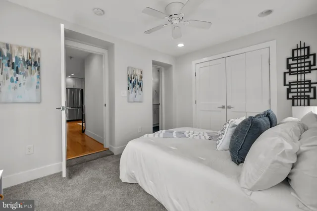 a bedroom with a bed and a painting