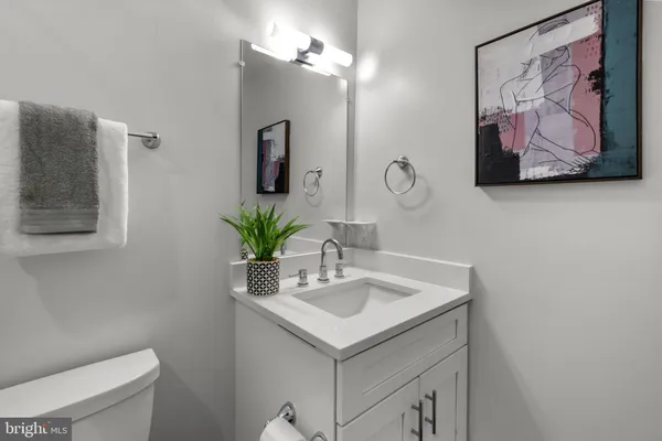 a bathroom with a sink a vanity and a toilet