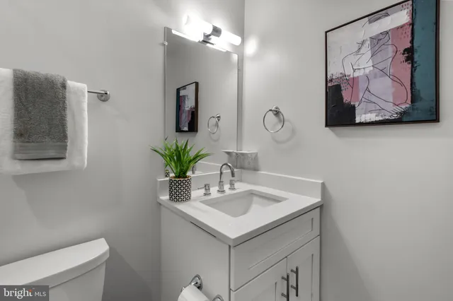 a bathroom with a sink a vanity and a toilet