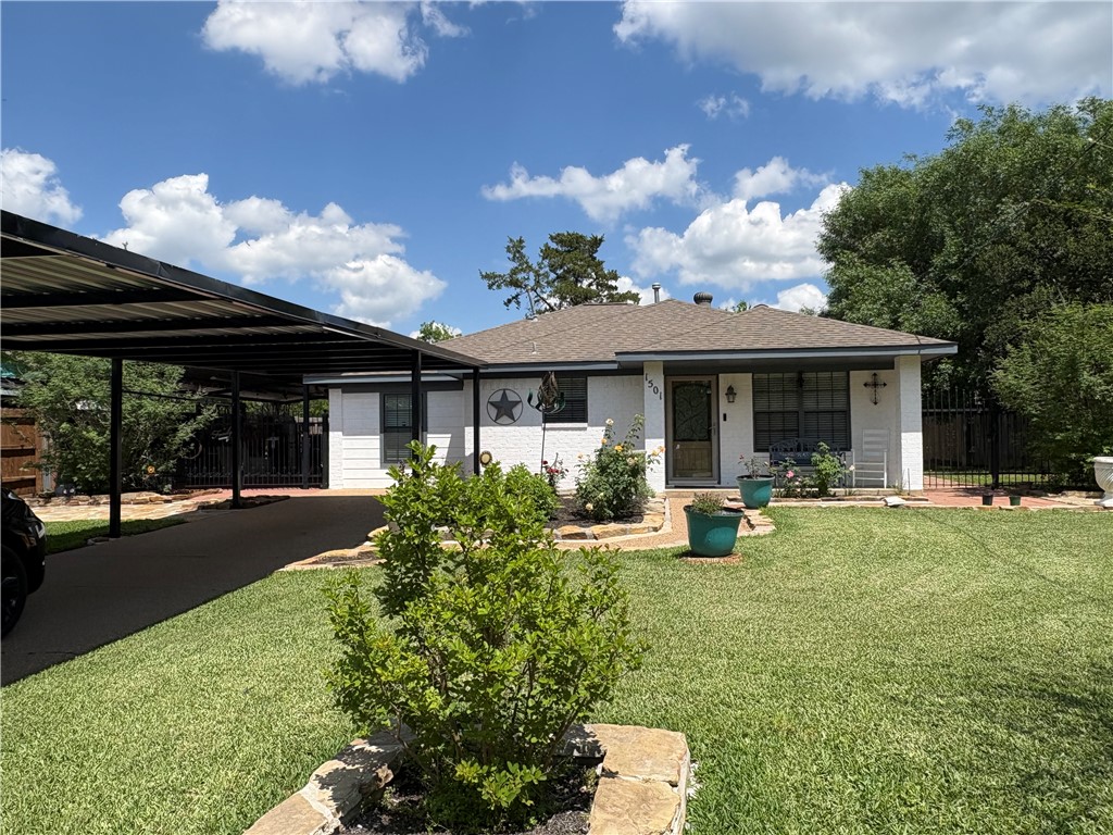 1501 Maple Drive Bryan, TX 77803 - Photo 2 of 19 a front view of a house with garden and porch