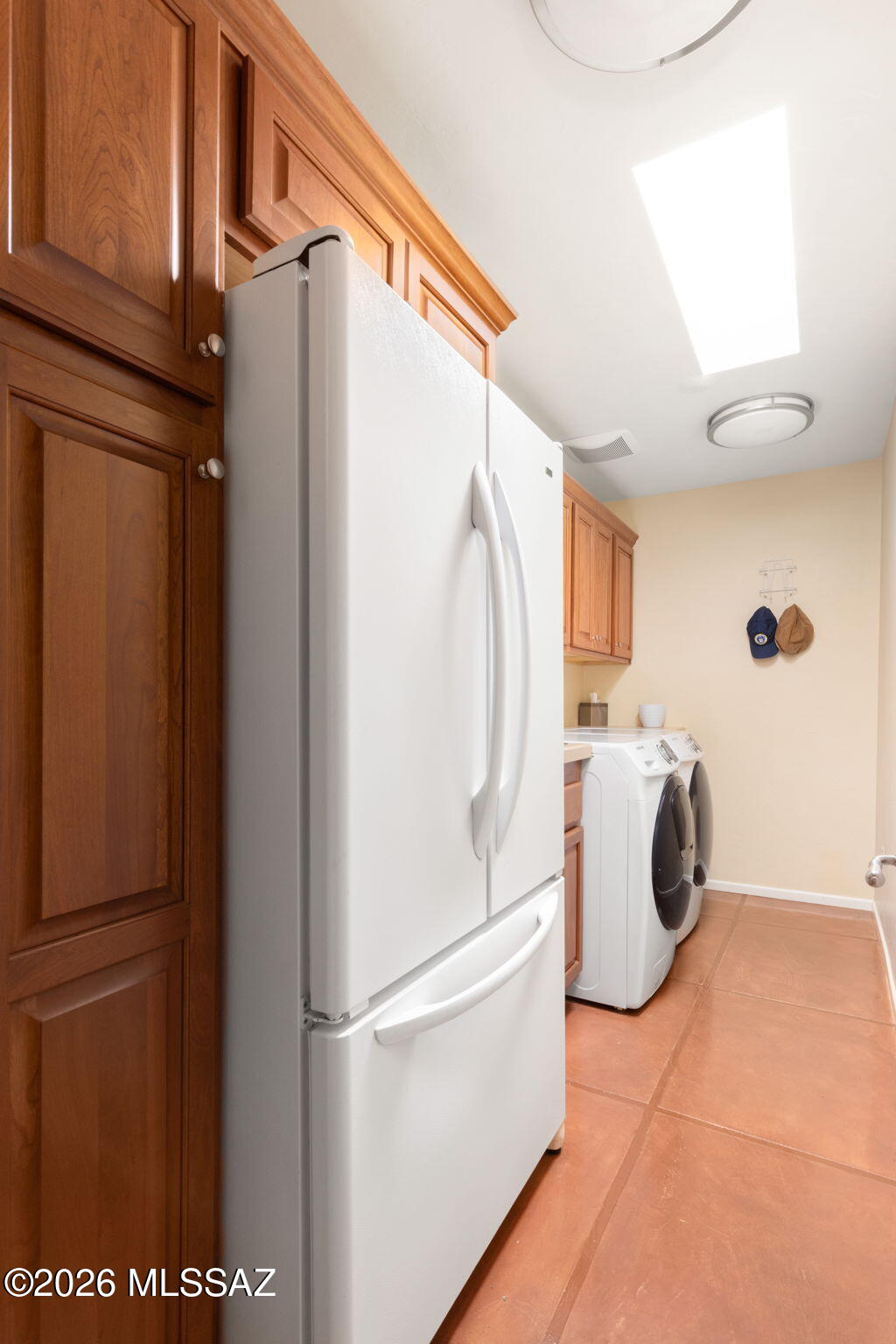 3575 North Pantano Road Tucson, AZ 85750 - Photo 36 of 51 Built-in cherry cabinet and complete with front load washer and dryer and French door refrigerator