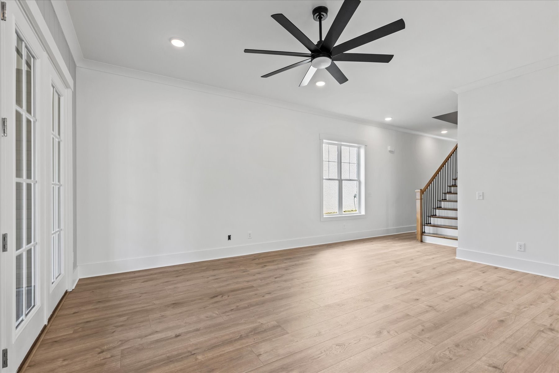 321 Old Shackle Island Road Hendersonville, TN 37075 - Photo 13 of 49 an empty room with wooden floor fan and windows