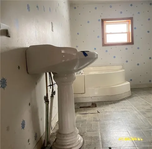 a bathroom with a tub and a shower