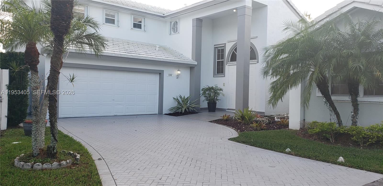 a view of a house with a yard and garage