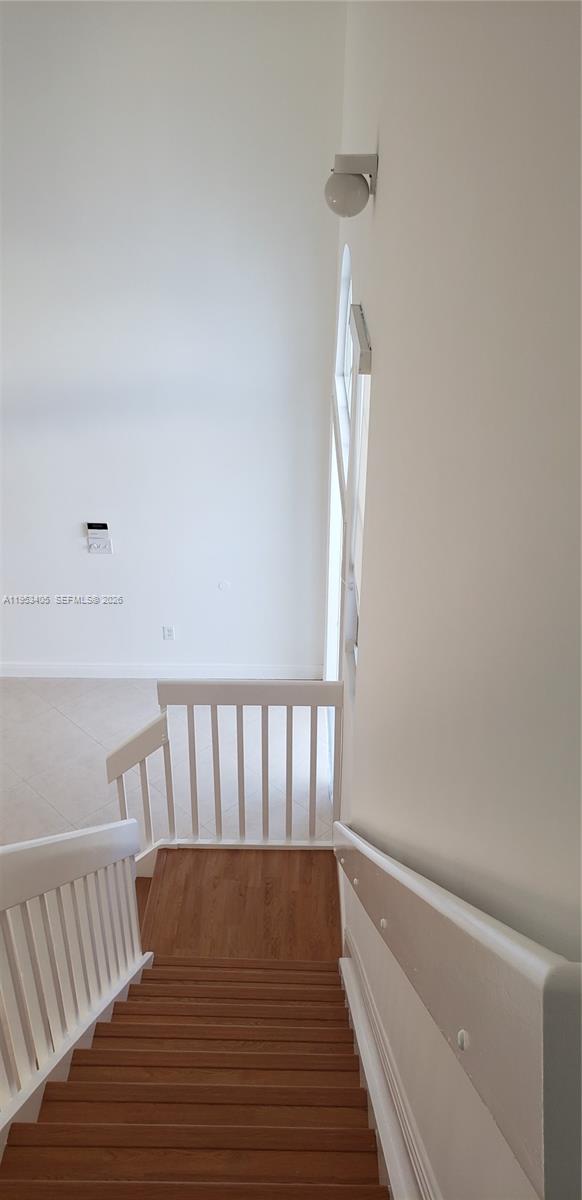 11242 Southwest 62nd Lane, Unit 11242 Miami, FL 33173 - Photo 41 of 58 a view of hallway with wooden floor and stairs