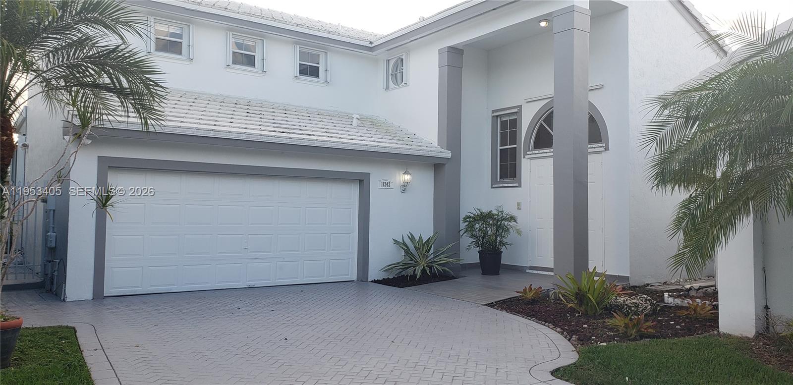 11242 Southwest 62nd Lane, Unit 11242 Miami, FL 33173 - Photo 53 of 58 a view of a house with a potted plant and a yard