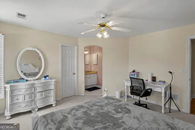 a bathroom with a granite countertop sink a large mirror and a shower