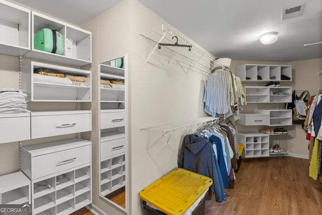 a view of a hallway with wooden floor and a fireplace