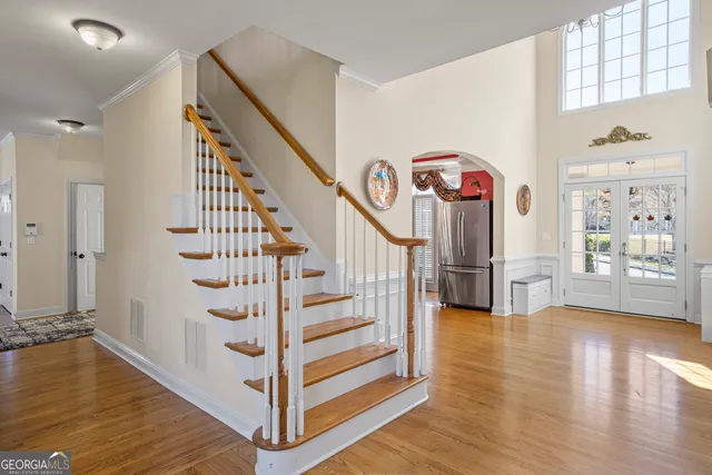 a view of entryway and hall with wooden floor