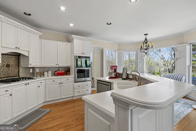 a kitchen with sink a stove and cabinets