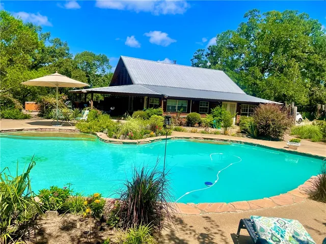 a view of a swimming pool and lounge chairs