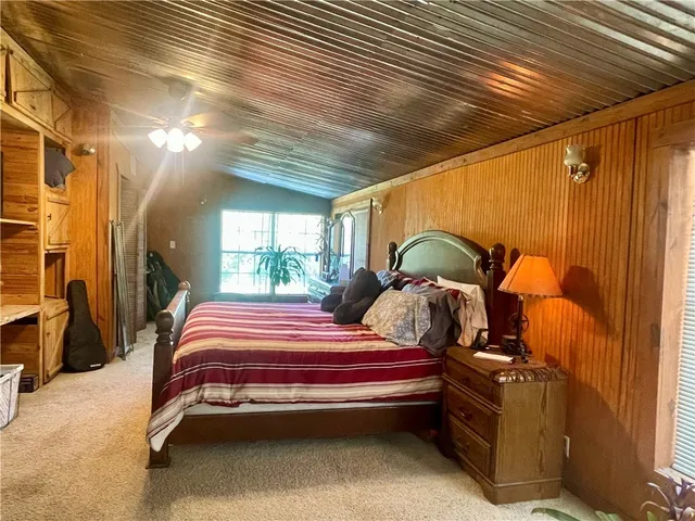 a bedroom with bed and a window