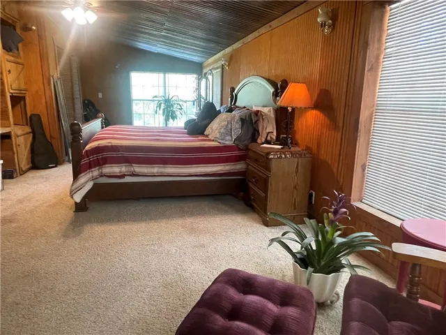 a bedroom with bed and a window