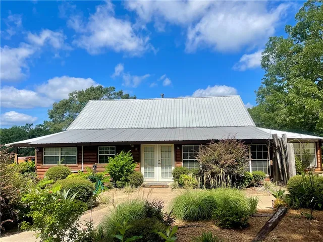 a view of a house with sitting area and garden